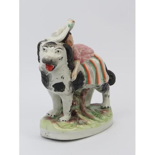 49 - A rare Staffordshire porcelain figural group depicting a girl riding a spaniel dog, mid 19th century... 