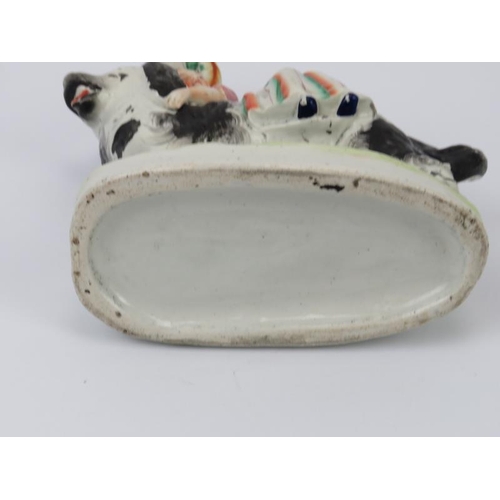 49 - A rare Staffordshire porcelain figural group depicting a girl riding a spaniel dog, mid 19th century... 