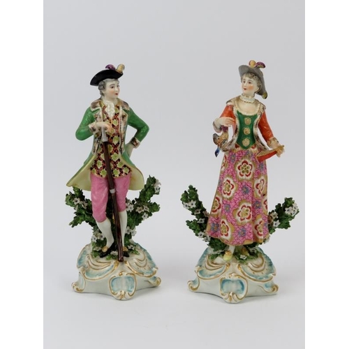 51 - A pair of European porcelain figurines depicting a huntsman and female companion, 19th century. Mode... 