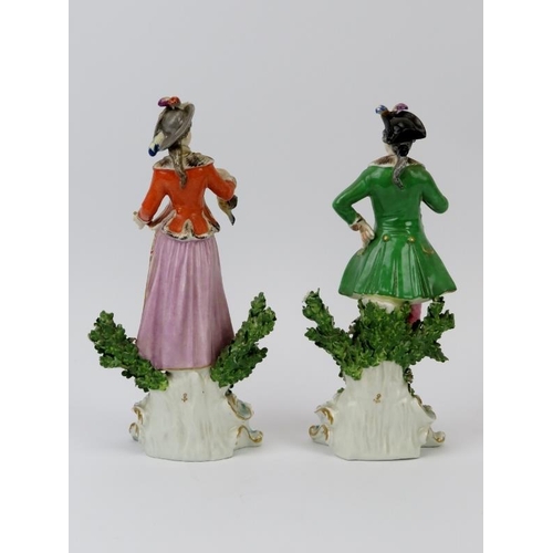 51 - A pair of European porcelain figurines depicting a huntsman and female companion, 19th century. Mode... 