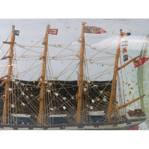 55 - A Victorian model clipper ship in a bottle. Flag to the third mast inscribed ‘Mary Ann’. Bottle with... 