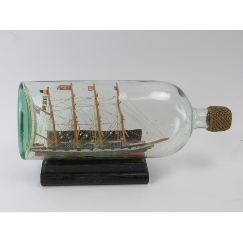 55 - A Victorian model clipper ship in a bottle. Flag to the third mast inscribed ‘Mary Ann’. Bottle with... 