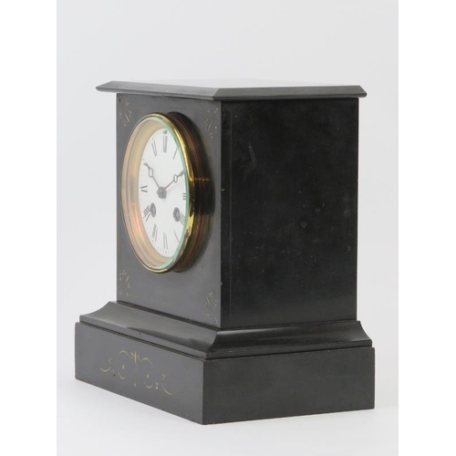 57 - A late Victorian black slate mantel clock. Key and pendulum included. 22 cm height. Condition report... 