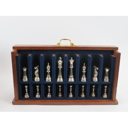 66 - A cherrywood cased chess set and board, late 20th century. With gilt metal chess pieces. The boards ... 