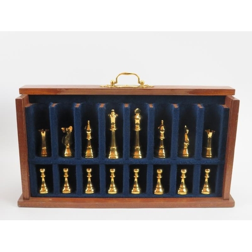 66 - A cherrywood cased chess set and board, late 20th century. With gilt metal chess pieces. The boards ... 