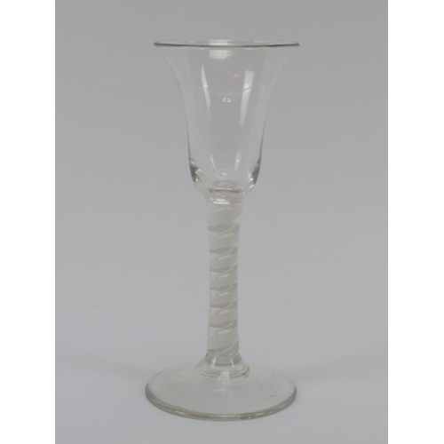 82 - A Georgian period English wine glass, 18th century. With an opaque double spiral twist stem and bell... 