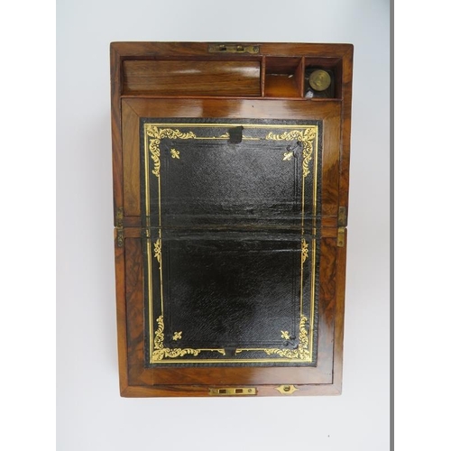 91 - A Victorian rosewood writing slope. With brass bands, a plain central cartouche and fitted interior.... 