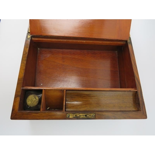 91 - A Victorian rosewood writing slope. With brass bands, a plain central cartouche and fitted interior.... 