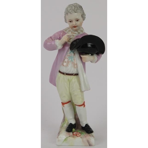 220 - A German KPM porcelain figurine of a boy holding a birds nest, late 18th/early 19th century. KPM sce... 