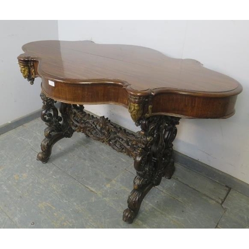 705 - An exceptional 19th century mahogany centre table, the shaped top above a plain frieze with four ind... 