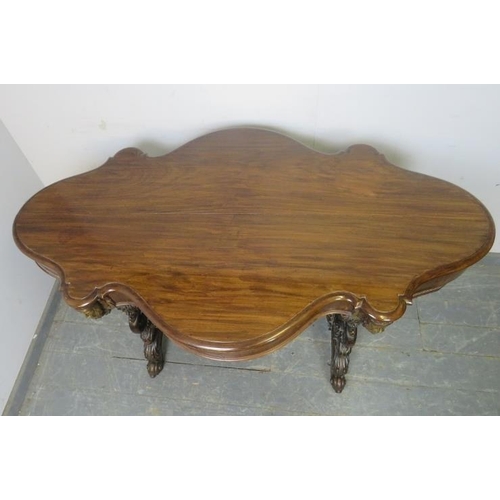 705 - An exceptional 19th century mahogany centre table, the shaped top above a plain frieze with four ind... 