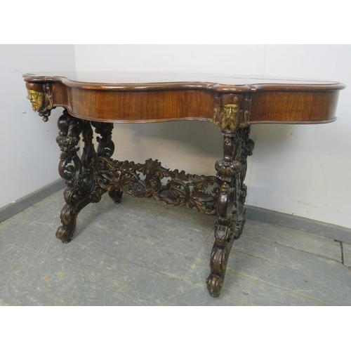 705 - An exceptional 19th century mahogany centre table, the shaped top above a plain frieze with four ind... 