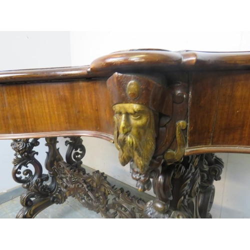 705 - An exceptional 19th century mahogany centre table, the shaped top above a plain frieze with four ind... 