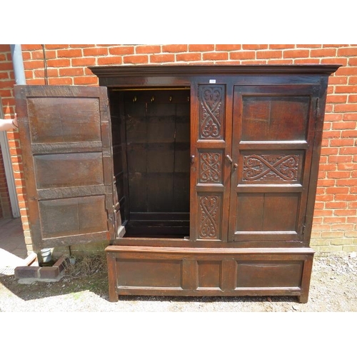 709 - A 17th century oak livery cupboard of good colour, having relief carved decoration and fielded side ... 