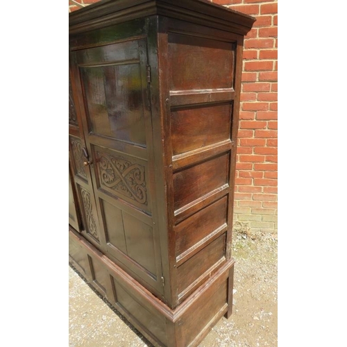 709 - A 17th century oak livery cupboard of good colour, having relief carved decoration and fielded side ... 