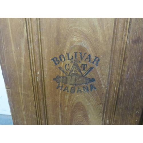 711 - An antique cedarwood cigar cabinet, the panelled doors and interior branded ‘Bolivar Habana’ above a... 