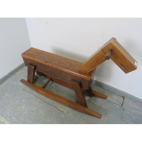 717 - A bespoke modernist rocking horse constructed using a variety of specimen hardwoods, with braided ro... 