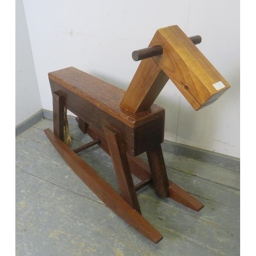 717 - A bespoke modernist rocking horse constructed using a variety of specimen hardwoods, with braided ro... 