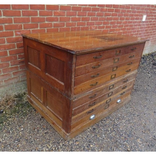 729 - A large early 20th century oak plan chest, housing eight long drawers with brass handles and label h... 