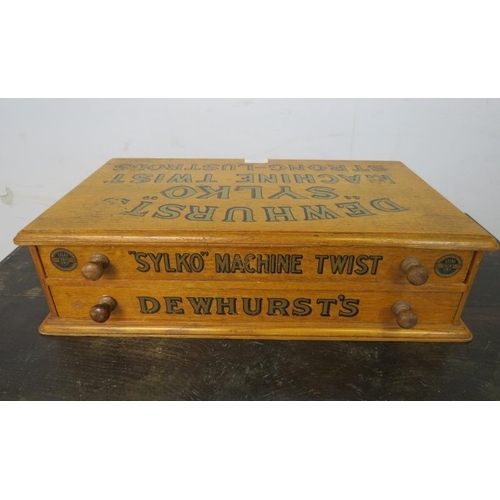 732 - An early 20th century golden oak Dewhurst ‘Sylko’ countertop cotton reel box, housing two long drawe... 