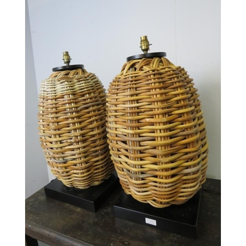 764 - A pair of large vintage wicker table lamps, on composite square plinth bases. 
H66cm W33cm D33cm (ap... 