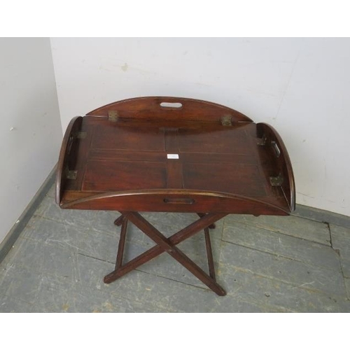 765 - A Georgian mahogany butler’s tray on stand, the tray top with hinged sides and pierced carry handles... 