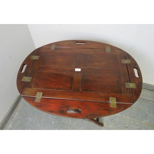 765 - A Georgian mahogany butler’s tray on stand, the tray top with hinged sides and pierced carry handles... 