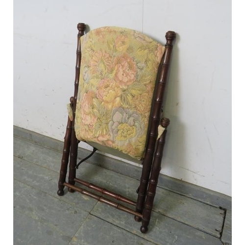 770 - An unusual 19th century child’s folding campaign chair, upholstered in tapestry material, on mahogan... 