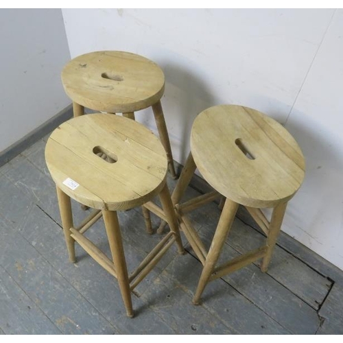 782 - Three beech artist’s stools with pierced seats, on turned supports with double side stretchers. 
H10... 