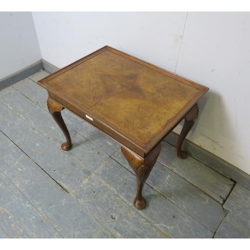 793 - An antique walnut coffee table, the quarter veneered top on shell carved cabriole supports. 
H59cm W... 