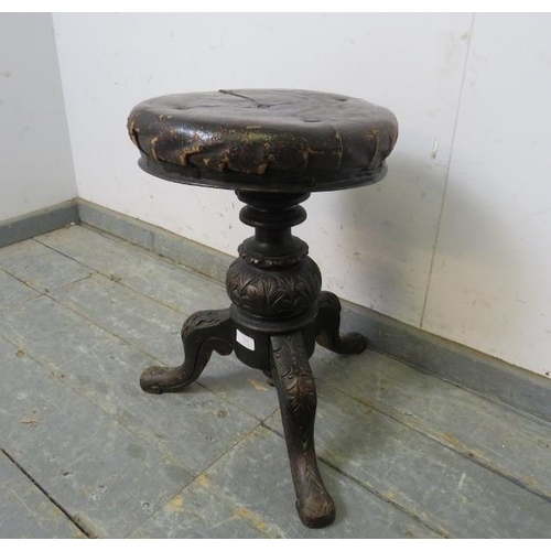 794 - A Victorian height-adjustable music stool, retaining the original buttoned leather upholstery, on an... 