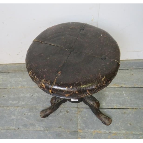 794 - A Victorian height-adjustable music stool, retaining the original buttoned leather upholstery, on an... 