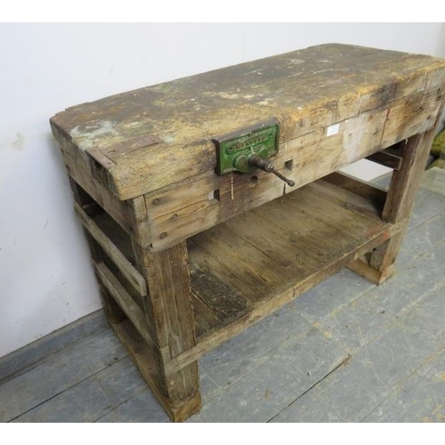 795 - An antique pine work bench of small proportions, fitted with a ‘Maples’ vice, on stile supports fitt... 