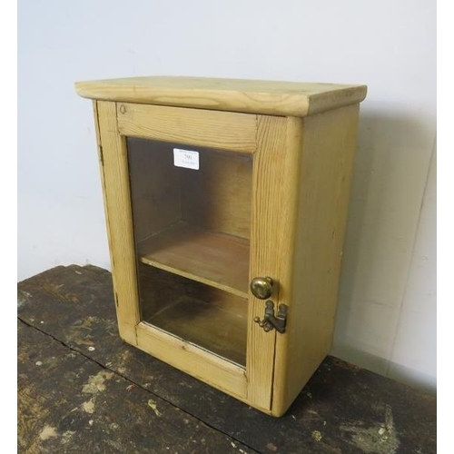 799 - A small antique pine wall cabinet, the glazed door with brass latch fitting opening onto a fitted sh... 