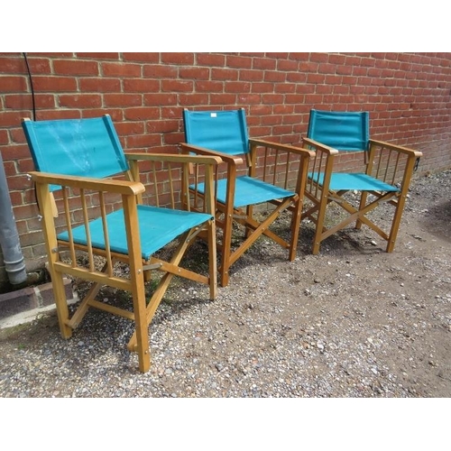 802 - Three folding director’s chairs, the beech frames with navy canvas seat material. 
H87cm W58cm D50cm... 