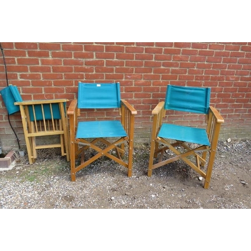 802 - Three folding director’s chairs, the beech frames with navy canvas seat material. 
H87cm W58cm D50cm... 