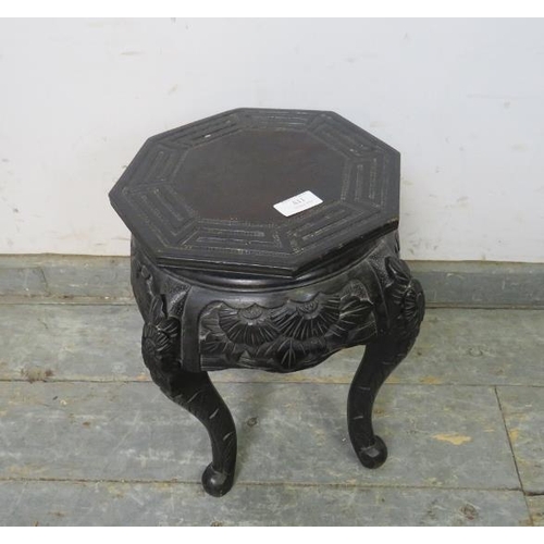 811 - A small Chinese octagonal ebonised plant stand in the 19th century taste, the relief carved frieze w... 