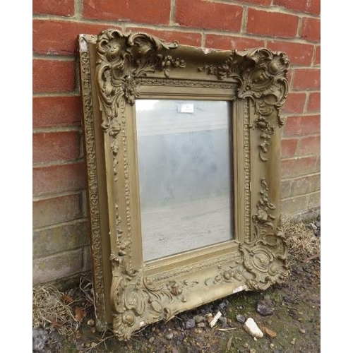 813 - A 19th century wall mirror, the antique silvered plate within a very ornate gilt gesso frame.  
H64c... 