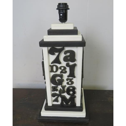 819 - A large table lamp with applied woodblock monochrome decoration, on a stepped plinth base.  
H53cm W... 