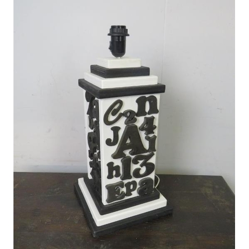 819 - A large table lamp with applied woodblock monochrome decoration, on a stepped plinth base.  
H53cm W... 