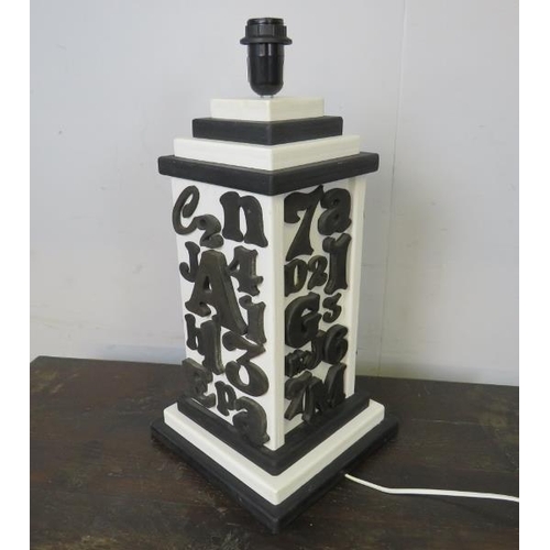 819 - A large table lamp with applied woodblock monochrome decoration, on a stepped plinth base.  
H53cm W... 