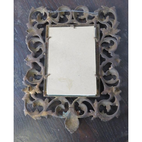 820 - A diminutive antique wall mirror, the gilt brass surround with egg and dart border amidst scrolling ... 