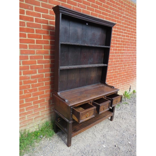 826 - A 19th century oak kitchen dresser in a 17th century taste, the moulded cornice above two open shelv... 