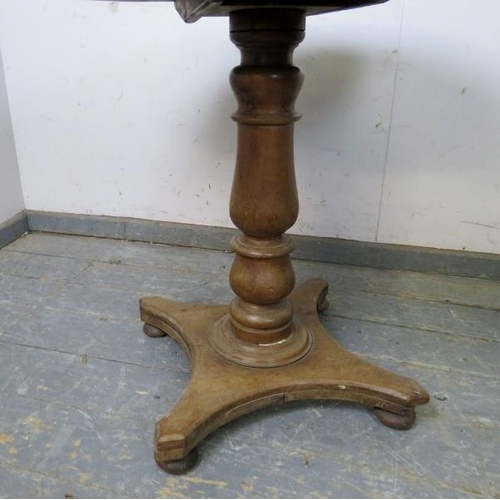 834 - A 19th century mahogany tilt-top table, on a baluster column, the quarterform base with bun feet. 
H... 