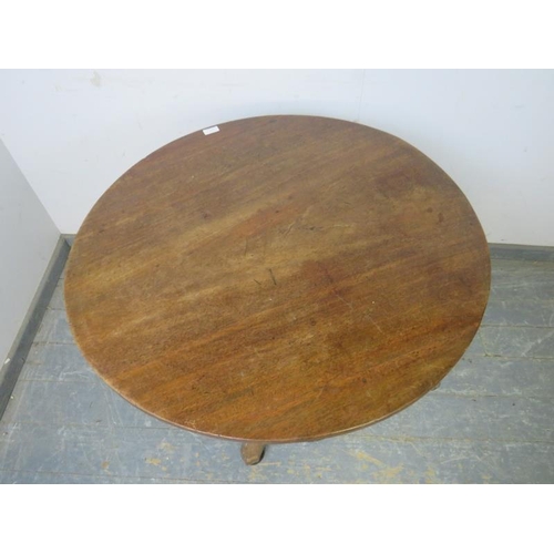 834 - A 19th century mahogany tilt-top table, on a baluster column, the quarterform base with bun feet. 
H... 