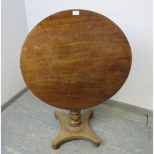 834 - A 19th century mahogany tilt-top table, on a baluster column, the quarterform base with bun feet. 
H... 