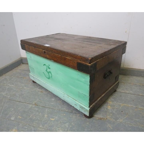 849 - An antique pine painted flat topped trunk/blanket box, metal bound and having carry handles to eithe... 