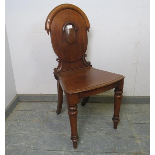 851 - A Victorian mahogany hall chair of good colour, the carved back with inverted finials, on tapered tu... 