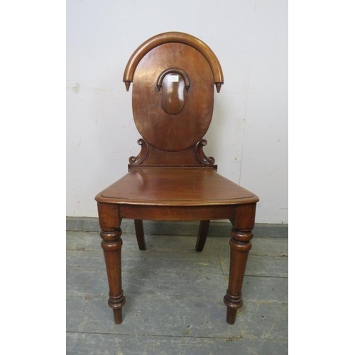 851 - A Victorian mahogany hall chair of good colour, the carved back with inverted finials, on tapered tu... 