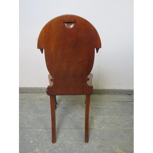 851 - A Victorian mahogany hall chair of good colour, the carved back with inverted finials, on tapered tu... 